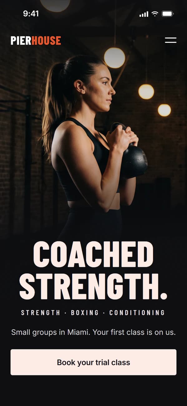 Mobile version of the Pierhouse example homepage: a dark photo of a woman holding a kettlebell at her chest, the headline “Coached strength.”, the programs strength, boxing and conditioning, and a “Book your trial class” button.
